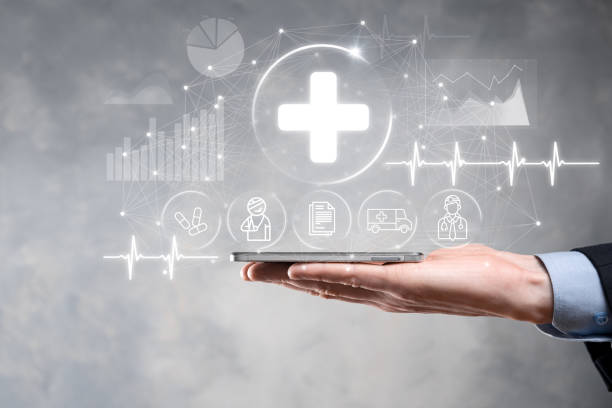 istock Businessman hold virtual plus medical network connection icons. Covid-19 pandemic develop people awareness and spread attention on their healthcare.Doctor,document,medicine,ambulance,patient icon. 1340253076