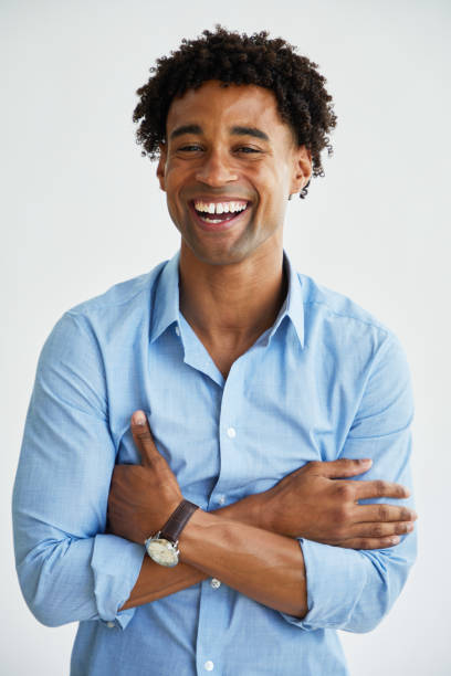 istock Young businessman laughing while standing against a white background 1340253132