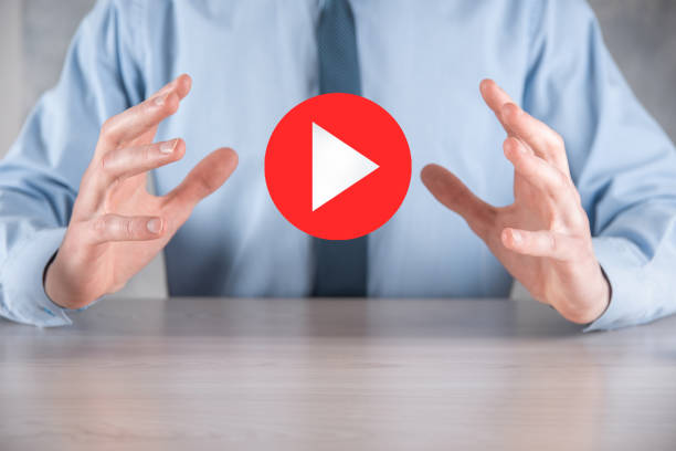 istock Businessman pressing, hold play button sign to start or initiate projects.Video Play Presentation. Idea for business, technology.media player button. Play icon.Go. 1340253995