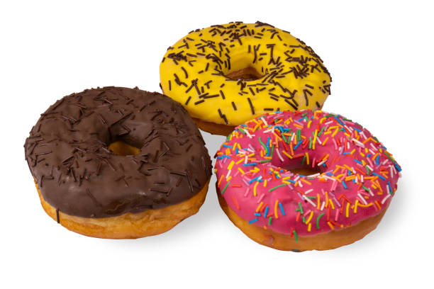 three donuts covered with chocolate and sugar icing and chocolate chips isolated on a white background - pastry bakery biscuit cookie imagens e fotografias de stock