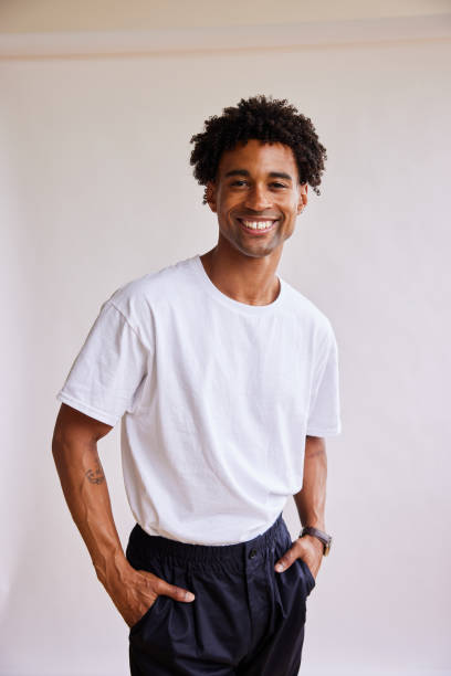istock Smiling young man standing with his hands in his pockets 1340257809