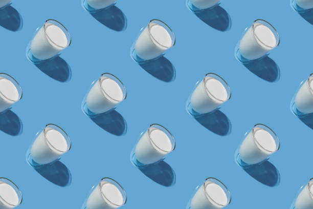 istock World Milk Day. Pattern on a blue background. A glass of milk. Pattern. 1340257830