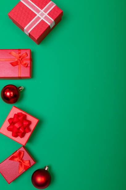 istock Composition of presents with bauble and copy space on green background 1340257866