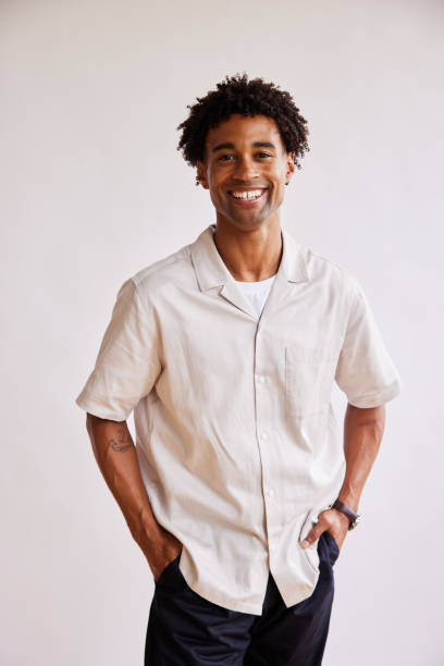istock Stylish young man smiling with his hands in his pockets 1340257867