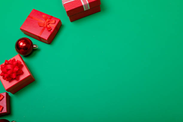 istock Composition of presents with bauble and copy space on green background 1340259951