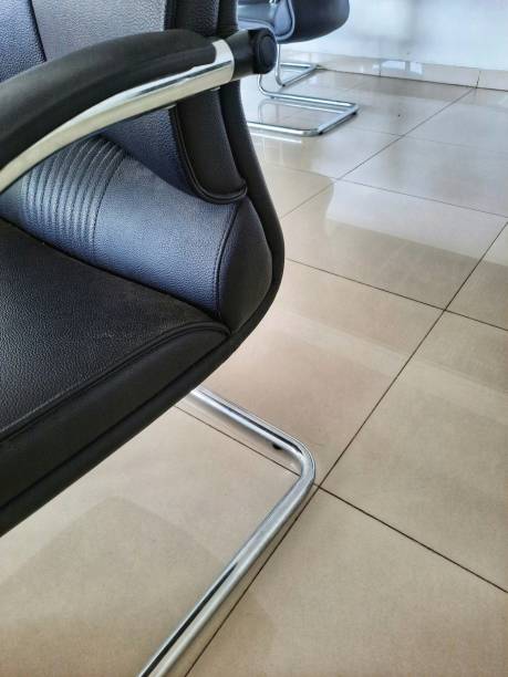 istock Office chair with a stainless frame on a large square cream floor background. Modern office furniture. 1340262189