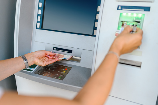 Woman making a cash withdrawal at an ATM