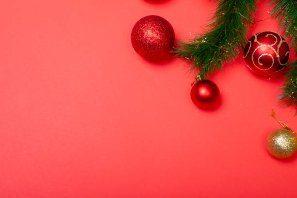 istock Composition of garland with baubles and copy space on red background 1340264813