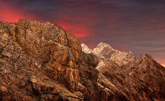 Zugspitze summit with the gold-plated summit cross and three mountaineers in the vicinity of the German Alps
