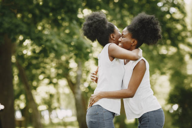istock Two young afro-american sisters hugging in a park 1340265734