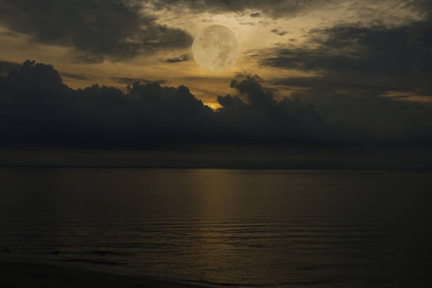 istock Full moon on sky over sea in the evening. 1340266381