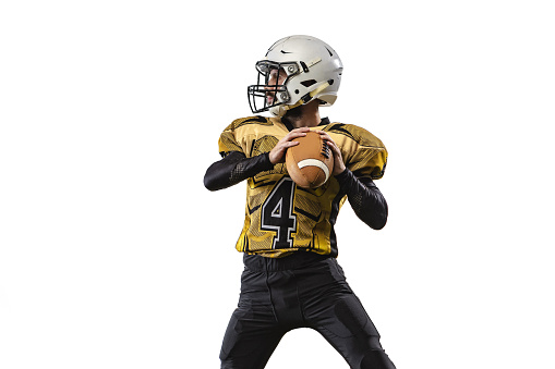 Portrait of professional sportsman, american football player throwing a ball isolated over white grass flooring background. Concept of active life, team game, energy, sport, competition, ad