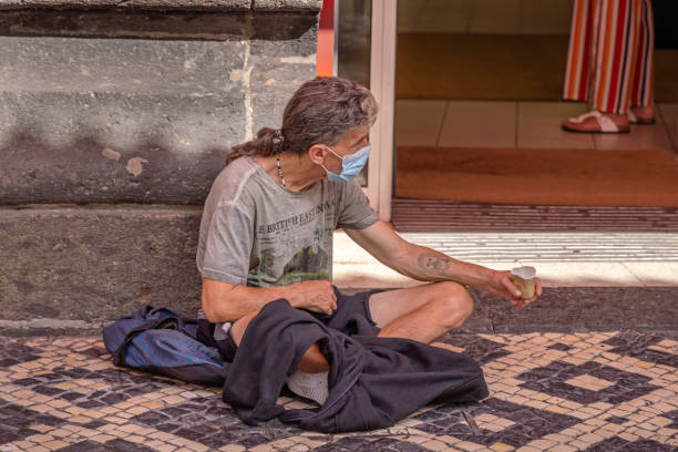 Man asking for money in the street in the Portuguese city Ponta Delgada which is the main city on the Azorean Island San Miguel in the center of the North Atlantic Ocean.
