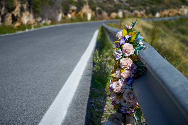 Flowers memorial symbol in a road stock photo