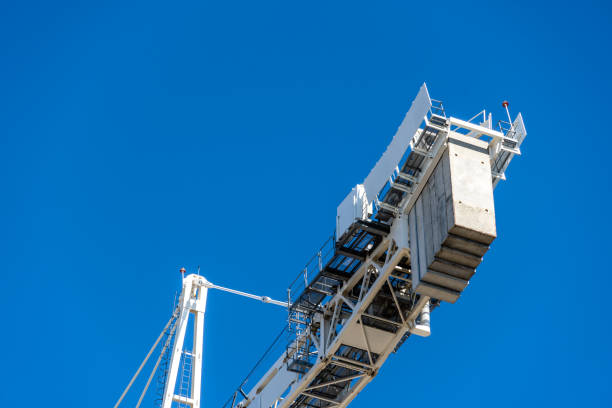 istock Close-up of construction crane against blue sky 1340276848
