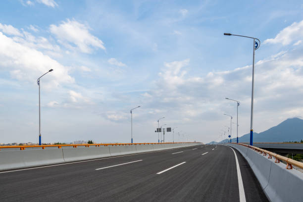 istock Empty asphalt highway road with city skyline. 1340277476