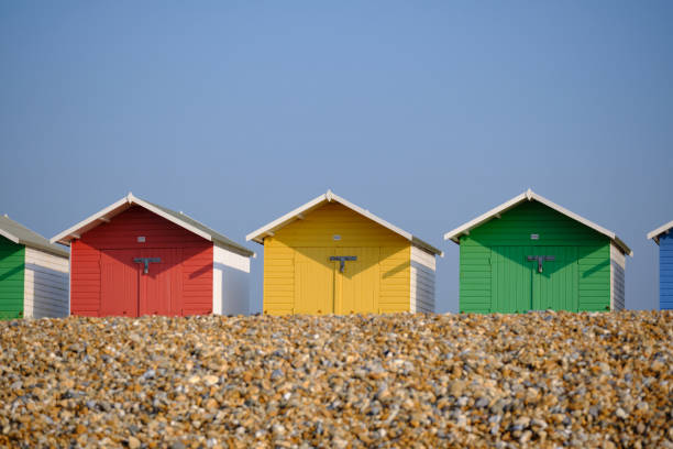 istock Multi-coloured beach huts in Eastbourne beneath a clear blue sky in the summer 1340278086