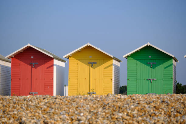 istock Multi-coloured beach huts in Eastbourne beneath a clear blue sky in the summer 1340278113