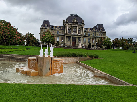 Public park and public building or Palace of Justice or the Cantonal Courthouse for Vaud in Lausanne Switzerland with statue to William Tell in front