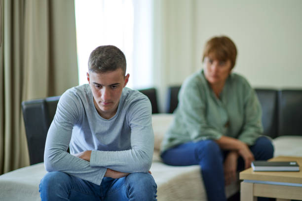 Sad teenage boy in troubles stock photo