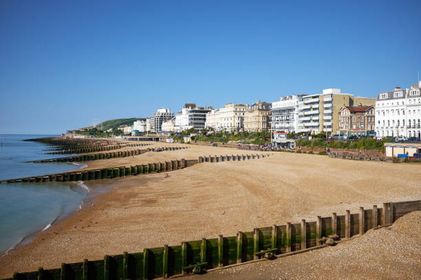 Eastbourne beach and Hotels, East Sussex, England. A summertime view across the seafront of the English seaside town with South Downs in the distance. Eastbourne beach and Hotels, East Sussex, England. A summertime view across the seafront of the English seaside town with South Downs in the distance. eastbourne pier photos stock pictures, royalty-free photos & images