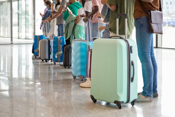 istock Passengers waiting in line at airport terminal 1340282272