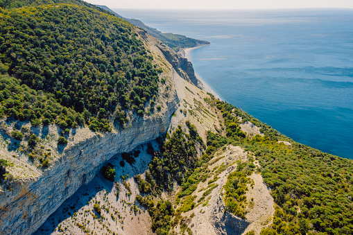 Aerial view of coastline with blue sea, mountains, canyon and cliffs with daylight