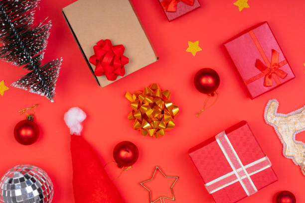 istock Composition of multiple christmas decorations with baubles and presents on red background 1340282520
