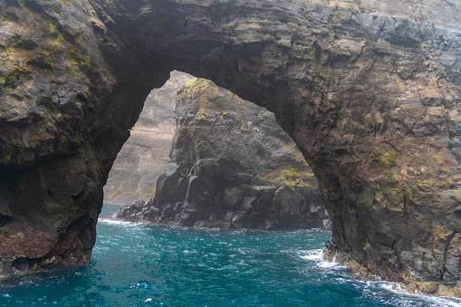 Stunning boat ride among the  steep bird cliffs, caves, narrow straits and grottoes of Vestmanna, Streymoy island, Faroe Islands