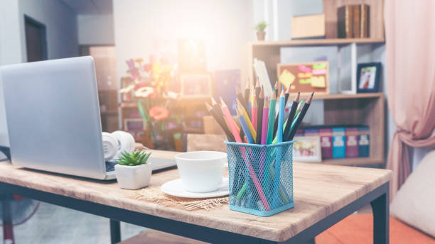 istock Desk for student concept. Desktop Laptop for study for exam, Computer, headphone, pencils, cactus, and cup of coffee place on School table for student work online at home. 1340288653