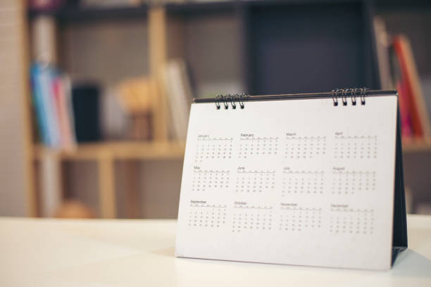 istock Calendar desk place on table. Desktop Calender for Planner to plan agenda, timetable, appointment, organization, management each date, month, and year on wooden office table.Calendar Concept. 1340288673