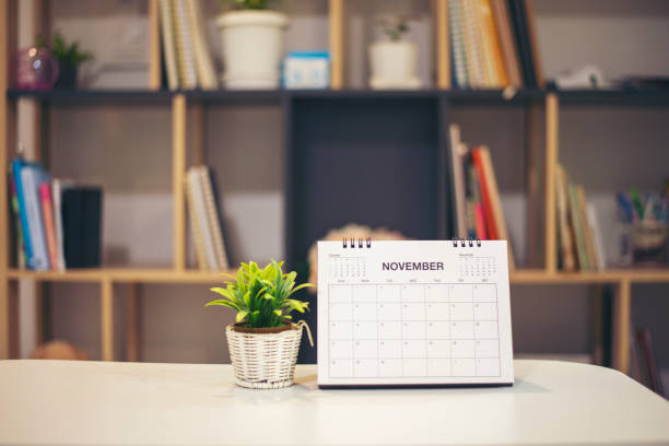 istock Calendar desk place on table. Desktop Calender for Planner to plan agenda, timetable, appointment, organization, management each date, month, and year on wooden office table.Calendar Concept. 1340288677