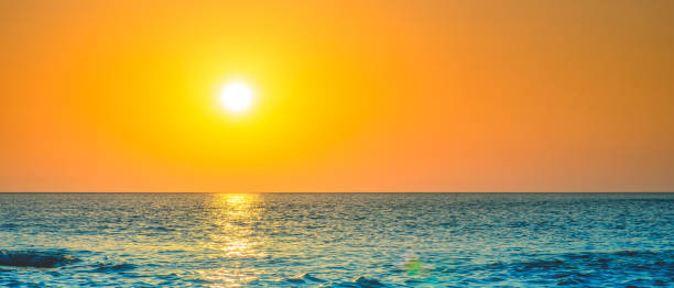 Golden sunset sky above endless sea surface