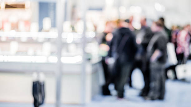 istock Blurred view of people standing in queue inside building, abstract defocused background 1340290919