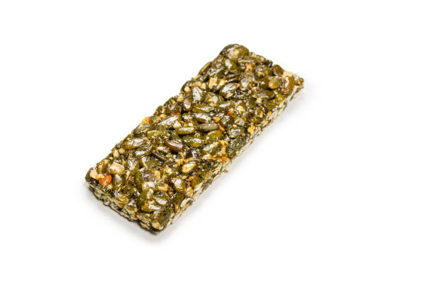 istock Bar with nuts isolated on a white background. Pumpkin seeds bar. 1340292840