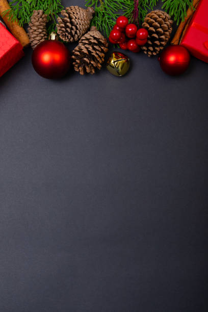istock Composition of christmas decorations with baubles, presents and copy space on black background 1340293149