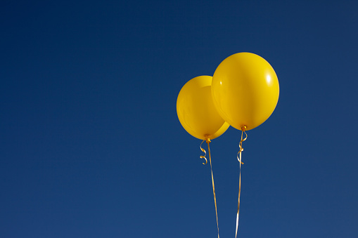 Yellow balloons on the sky background. Copy space