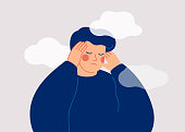 istock A sad young man has a clouded mind on blue background. A depressed teenager boy suffers from temporary memory loss and confusion. 1340294219