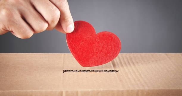 istock Male hand putting red heart in box. 1340294259