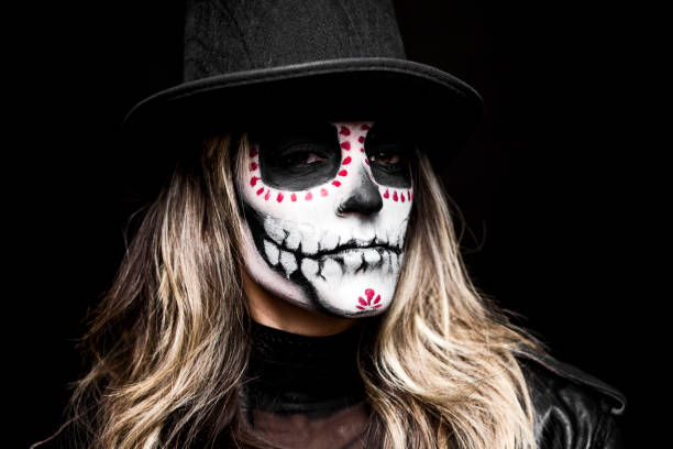 istock Sugar skull creative make up costume for Halloween ,woman with top hat 1340294563