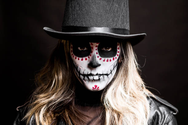 istock Woman with Halloween make up wearing top hat 1340294604
