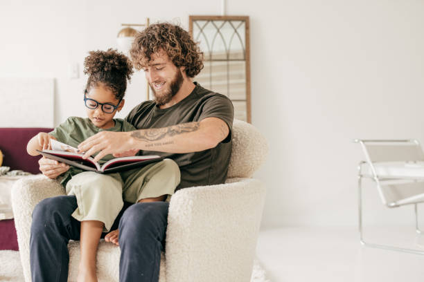 Dad and daughter reading a book together