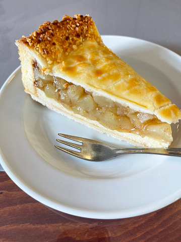 slice of apple pie with fork on plate
