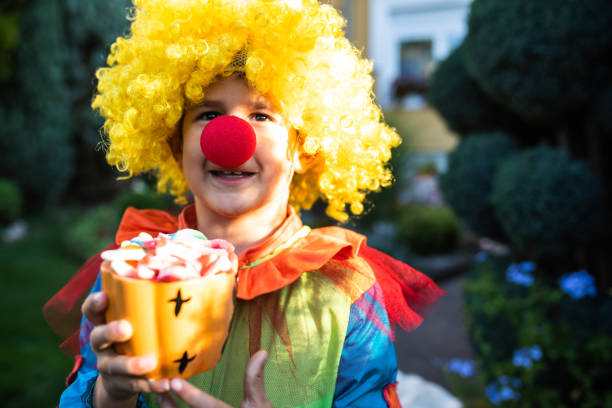 istock A happy boy clown trick-or-treating 1340297961