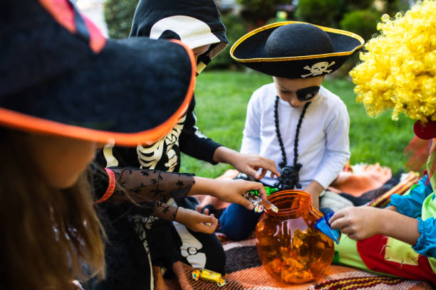 istock Kids in costumes with Halloween candy 1340298001
