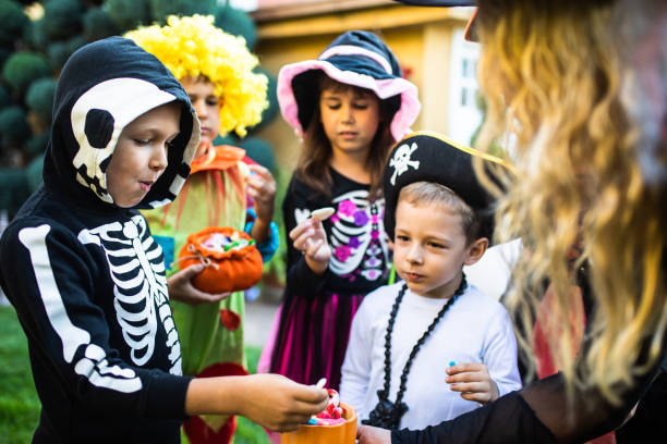 istock Cute kids stuffing their faces with Halloween candy 1340298053