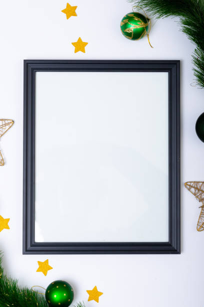 istock Composition of frame with copy space and fir tree branches with baubles on white background 1340298635