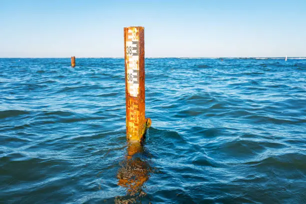Photo of Water depth measurement tool or sea level marker.