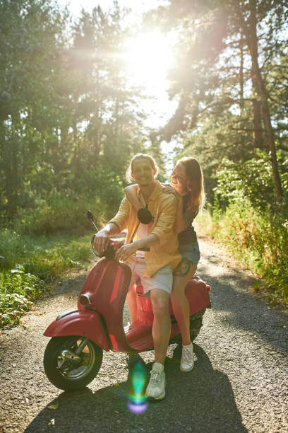 istock Happy young caucasian spouses sitting on scooter 1340300907