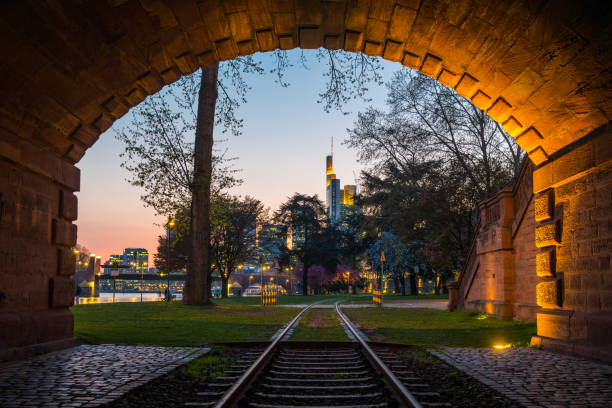 istock Frankfurt sunset skyscrapers framed by railway tunnel beside Main Germany 1340303101